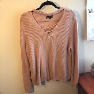 Mauve pink lace up sweater with choker detail.